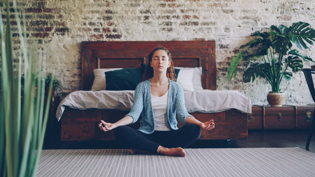 Woman meditating cross-legged on the floor